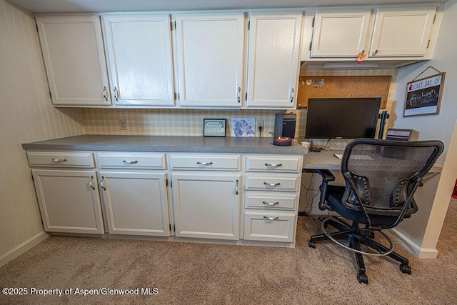 office space featuring baseboards and light carpet