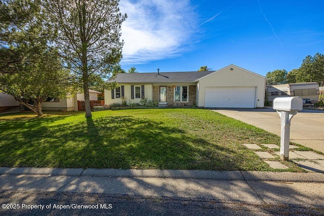 ranch-style home featuring a garage, driveway, and a front lawn