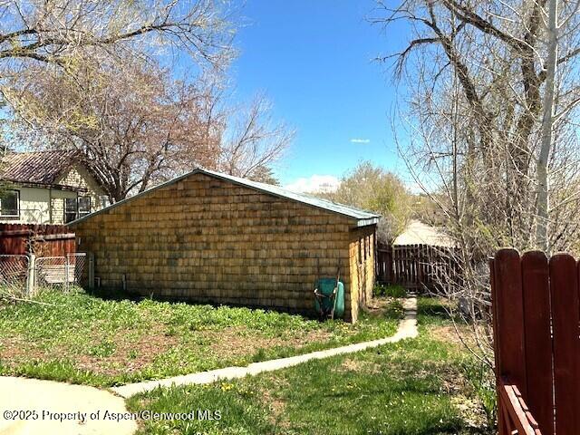 900 Breeze St, Craig, CO 81625 - view of side of home featuring fence
