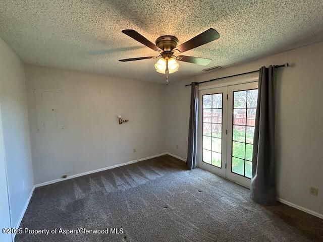 900 Breeze St, Craig, CO 81625 - unfurnished room with a textured ceiling, carpet, a ceiling fan, baseboards, and visible vents