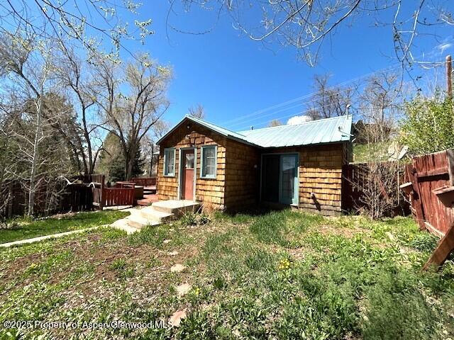 900 Breeze St, Craig, CO 81625 - back of property with fence and metal roof