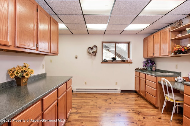 368 Meadow Ln, Glenwood Springs, CO 81601 - kitchen featuring baseboard heating, open shelves, light wood finished floors, dark countertops, and a drop ceiling