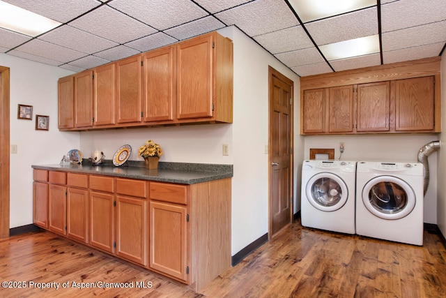 368 Meadow Ln, Glenwood Springs, CO 81601 - laundry room with cabinet space, washing machine and clothes dryer, light wood finished floors, and baseboards