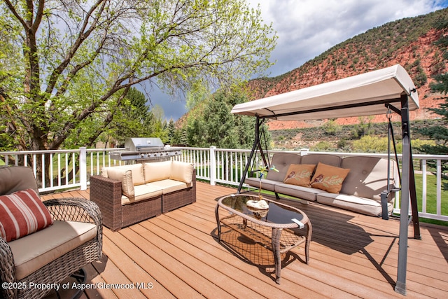 368 Meadow Ln, Glenwood Springs, CO 81601 - wooden terrace with an outdoor living space, a mountain view, and area for grilling