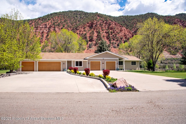 368 Meadow Ln, Glenwood Springs, CO 81601 - view of front facade featuring an attached garage, concrete driveway, and a mountain view