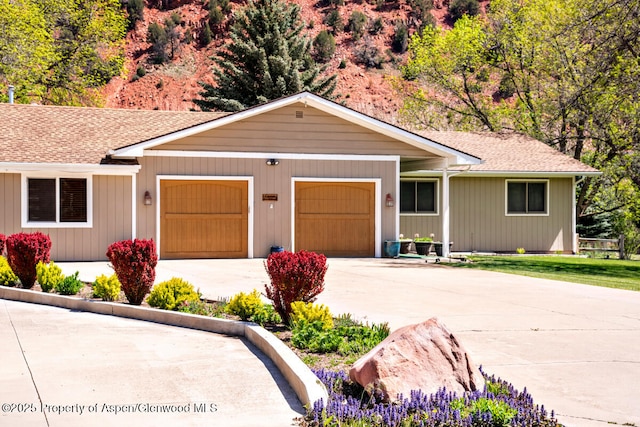 368 Meadow Ln, Glenwood Springs, CO 81601 - ranch-style home featuring concrete driveway, a garage, and a shingled roof