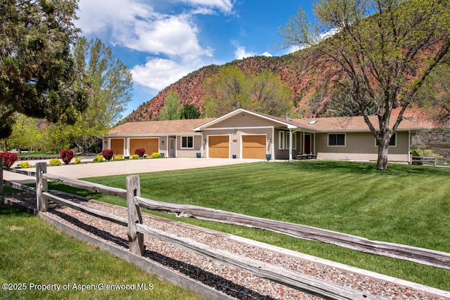 368 Meadow Ln, Glenwood Springs, CO 81601 - ranch-style house with a garage, a mountain view, and concrete driveway