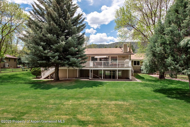 368 Meadow Ln, Glenwood Springs, CO 81601 - rear view of house with a wooden deck, a lawn, stairway, and a chimney