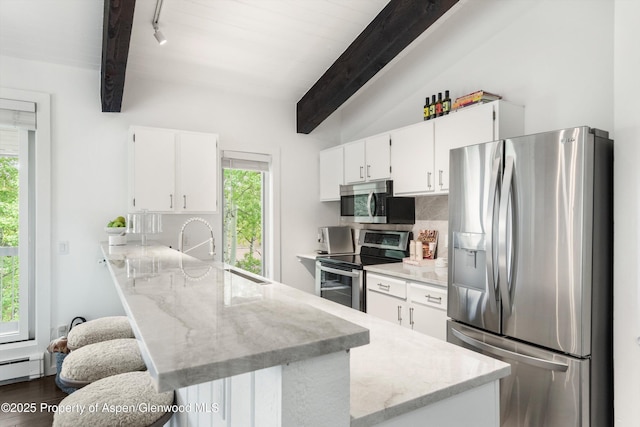 35 Upper Woodbridge Rd Unit 18-Cd, Snowmass Village, CO 81615 - kitchen with stainless steel appliances, a peninsula, beamed ceiling, white cabinetry, and light stone countertops