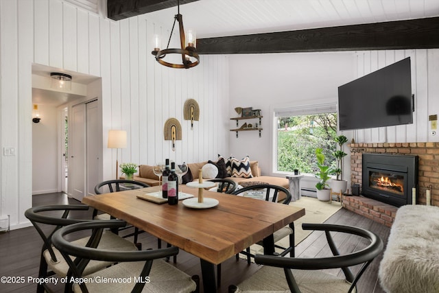 35 Upper Woodbridge Rd Unit 18-Cd, Snowmass Village, CO 81615 - dining room featuring wood finished floors, a fireplace, beamed ceiling, wood walls, and a chandelier