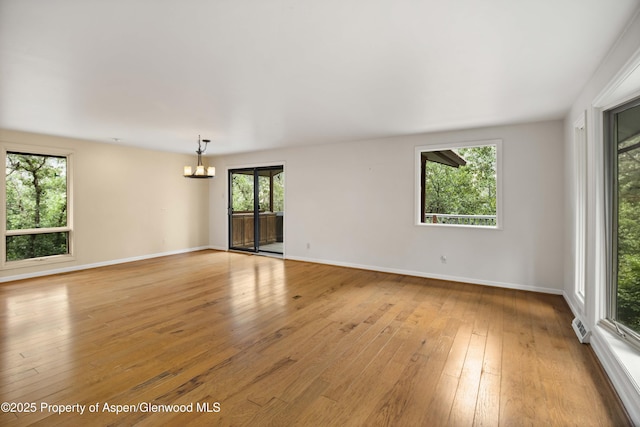 912 Red Mountain Dr, Glenwood Springs, CO 81601 - empty room with a chandelier and light wood-type flooring
