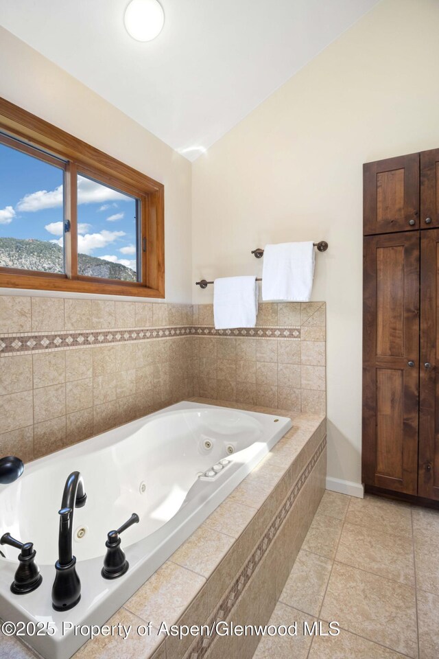 912 Red Mountain Dr, Glenwood Springs, CO 81601 - bathroom with a tub with jets and tile patterned flooring