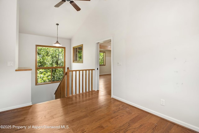 912 Red Mountain Dr, Glenwood Springs, CO 81601 - unfurnished room featuring healthy amount of natural light, ceiling fan, wood finished floors, and high vaulted ceiling