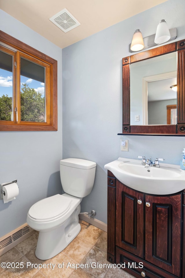 912 Red Mountain Dr, Glenwood Springs, CO 81601 - half bath featuring vanity, a baseboard radiator, and tile patterned flooring