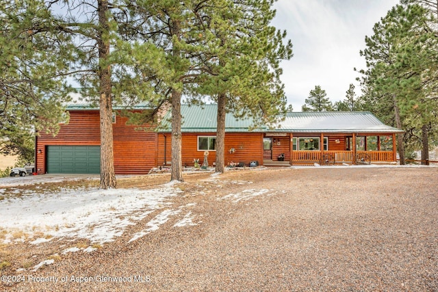 view of front of property with a porch and a garage