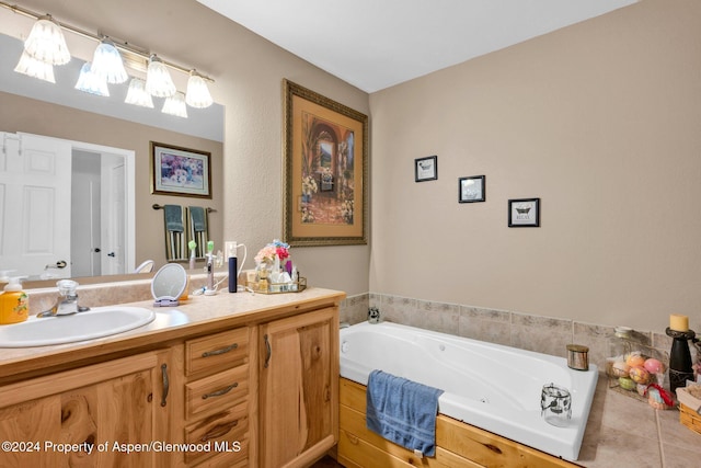 bathroom featuring tile patterned floors, a tub, and vanity