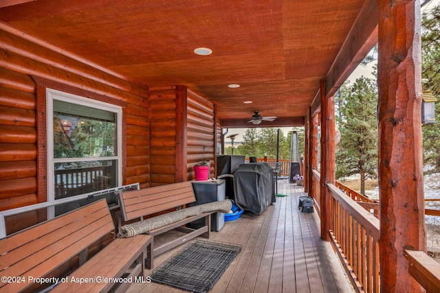 wooden terrace with grilling area and ceiling fan