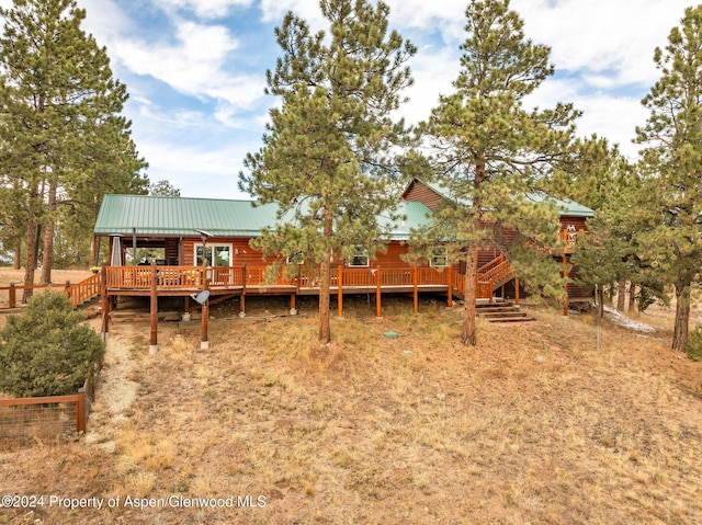 back of property with a wooden deck