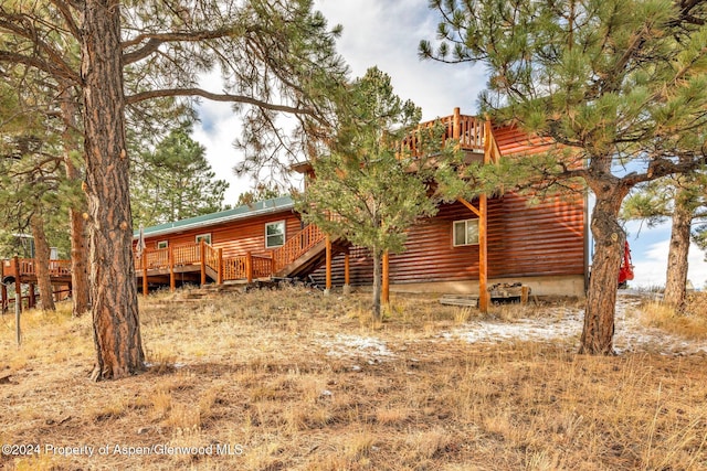 back of property featuring a wooden deck