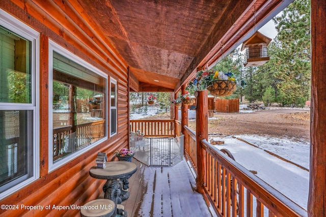 snow covered deck with covered porch