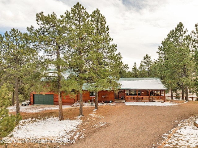 view of front of property featuring covered porch and a garage