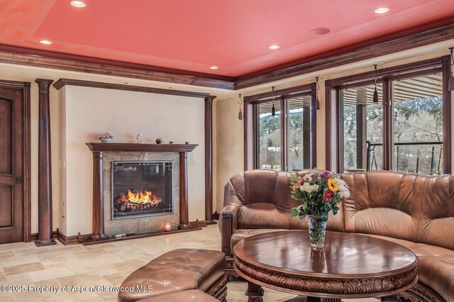 81 River Park Ln, Carbondale, CO 81623 - living room featuring baseboards, recessed lighting, a glass covered fireplace, and crown molding