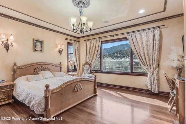 81 River Park Ln, Carbondale, CO 81623 - bedroom with a chandelier, dark wood-type flooring, baseboards, and crown molding