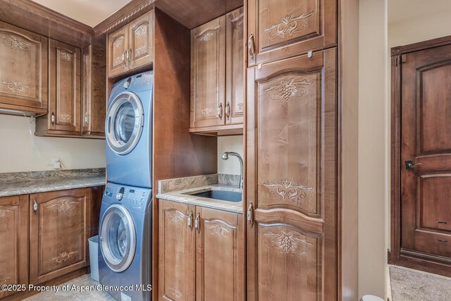 81 River Park Ln, Carbondale, CO 81623 - laundry area with stacked washer / dryer and cabinet space