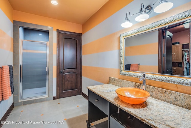81 River Park Ln, Carbondale, CO 81623 - bathroom featuring baseboards, a shower stall, vanity, tile patterned flooring, and a closet