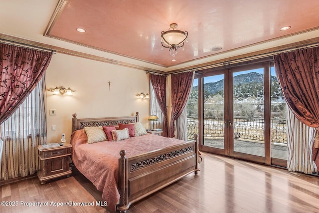 81 River Park Ln, Carbondale, CO 81623 - bedroom featuring access to outside, wood finished floors, a mountain view, ornamental molding, and french doors