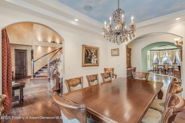 81 River Park Ln, Carbondale, CO 81623 - dining area with a chandelier, arched walkways, stairway, wood finished floors, and crown molding