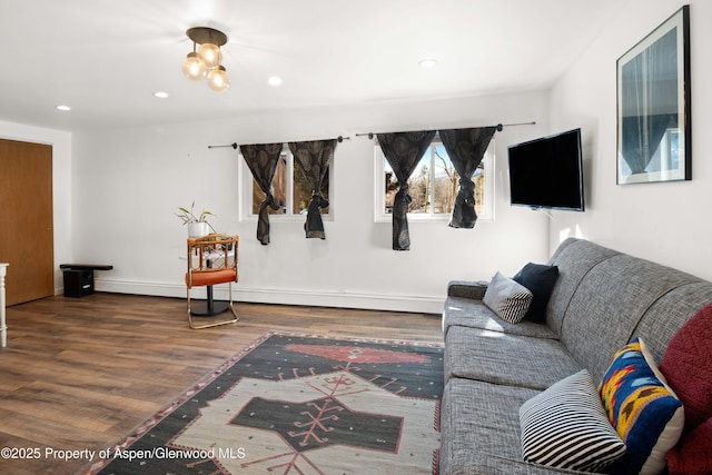 living room with baseboards, wood finished floors, and recessed lighting