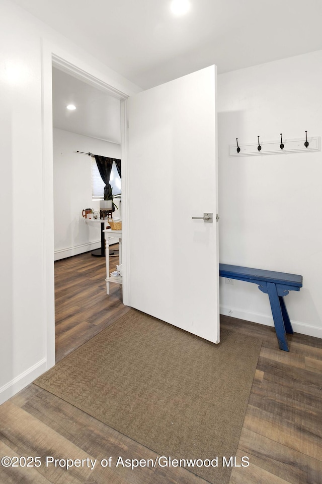 hallway with recessed lighting, wood finished floors, and baseboards