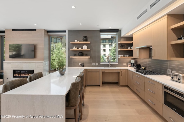 130 Wood Rd Unit 264, Snowmass Village, CO 81615 - kitchen featuring open shelves, gas cooktop, modern cabinets, light brown cabinetry, and recessed lighting