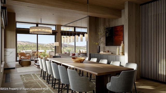 221 Wood Rd Unit 718, Snowmass Village, CO 81615 - dining area featuring wood finished floors, a mountain view, expansive windows, and wood ceiling