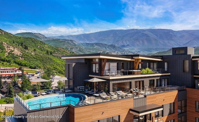 221 Wood Rd Unit 718, Snowmass Village, CO 81615 - rear view of house with a mountain view and a community pool