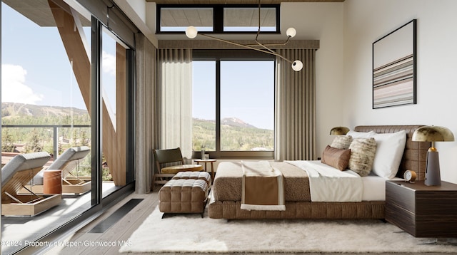 221 Wood Rd Unit 718, Snowmass Village, CO 81615 - bedroom with multiple windows, wood finished floors, and a mountain view