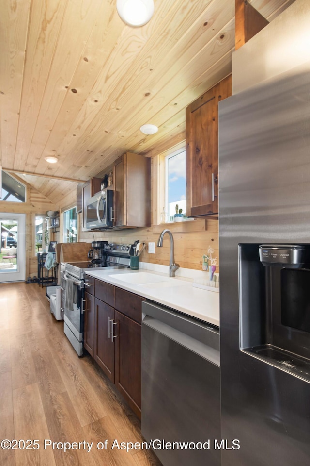 329 River Frontage Rd Unit 65, Silt, CO 81652 - kitchen with appliances with stainless steel finishes, a sink, healthy amount of natural light, light wood-type flooring, and vaulted ceiling