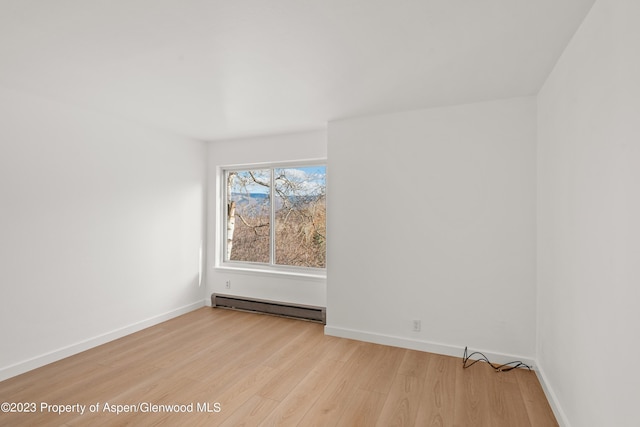 35 Lower Woodbridge Rd Unit B107, Snowmass Village, CO 81615 - unfurnished room with a baseboard radiator, light wood-style floors, and baseboards