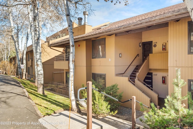 35 Lower Woodbridge Rd Unit B107, Snowmass Village, CO 81615 - view of front of house featuring stairs and a shingled roof