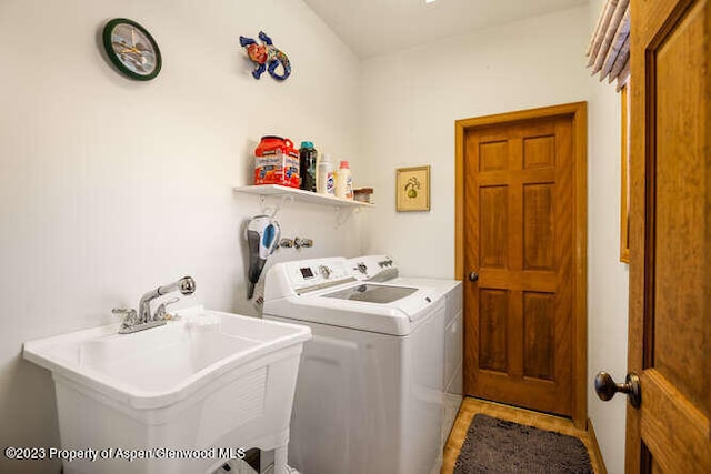 laundry area with washing machine and dryer and sink