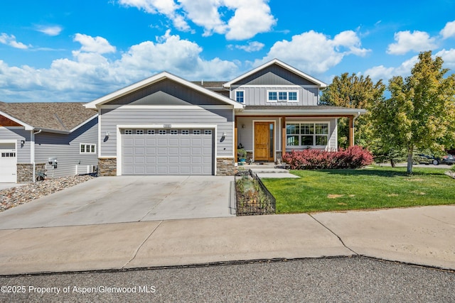 510 S Wildhorse Dr, New Castle, CO 81647 - craftsman house with board and batten siding, a front yard, concrete driveway, stone siding, and a garage