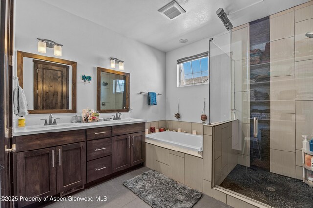 510 S Wildhorse Dr, New Castle, CO 81647 - bathroom featuring double vanity, a shower stall, a bath, and tile patterned flooring