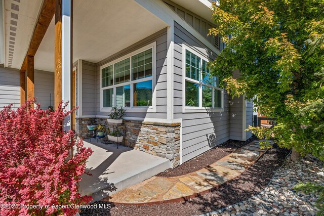 510 S Wildhorse Dr, New Castle, CO 81647 - view of exterior entry featuring covered porch and stone siding