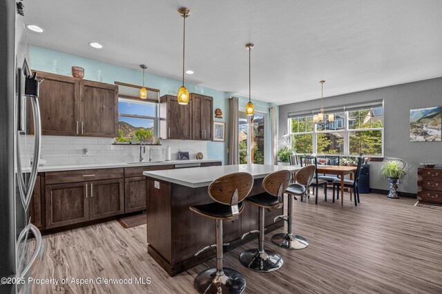 510 S Wildhorse Dr, New Castle, CO 81647 - kitchen featuring stainless steel refrigerator, a sink, light wood-type flooring, light countertops, and a center island