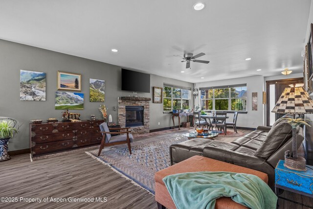 510 S Wildhorse Dr, New Castle, CO 81647 - living room featuring baseboards, a ceiling fan, recessed lighting, a fireplace, and wood finished floors