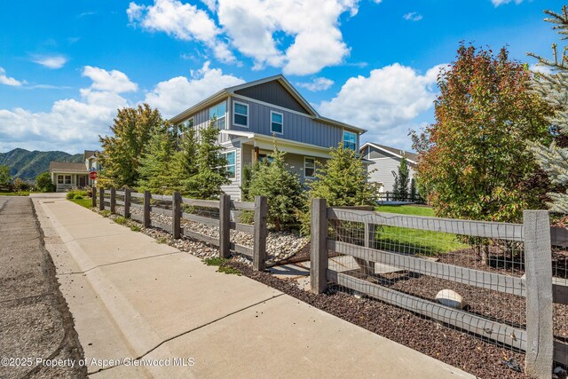 510 S Wildhorse Dr, New Castle, CO 81647 - view of home's exterior featuring board and batten siding, a mountain view, and a vegetable garden