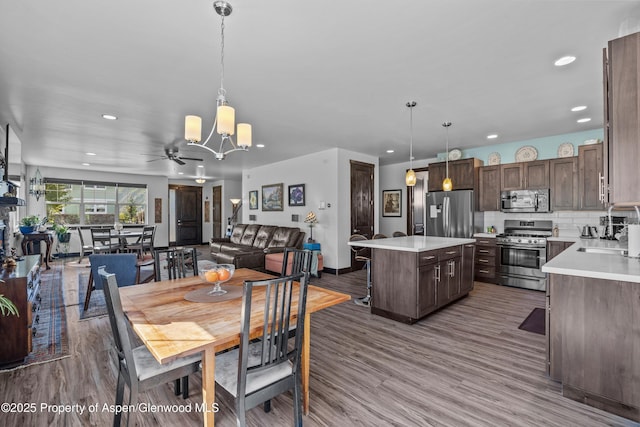 510 S Wildhorse Dr, New Castle, CO 81647 - dining space with recessed lighting, a chandelier, wood finished floors, baseboards, and ceiling fan