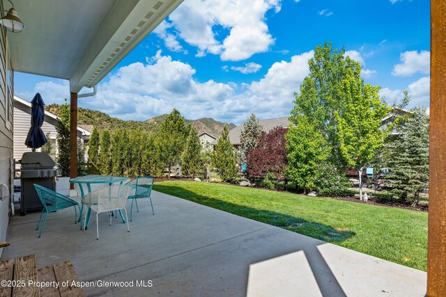 510 S Wildhorse Dr, New Castle, CO 81647 - view of patio featuring grilling area, outdoor dining space, and a mountain view