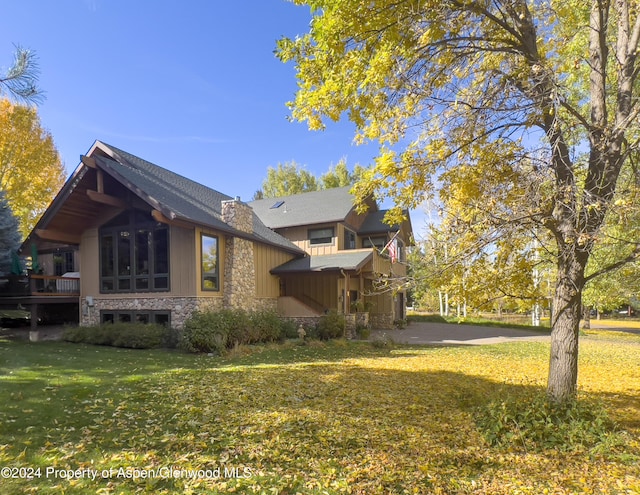 view of side of home featuring a lawn